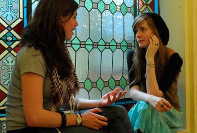 Two girls of different nationalities communicate in Spanish