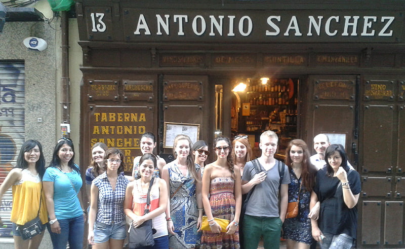 Group of foreign boys in front of a tavern in Madrid